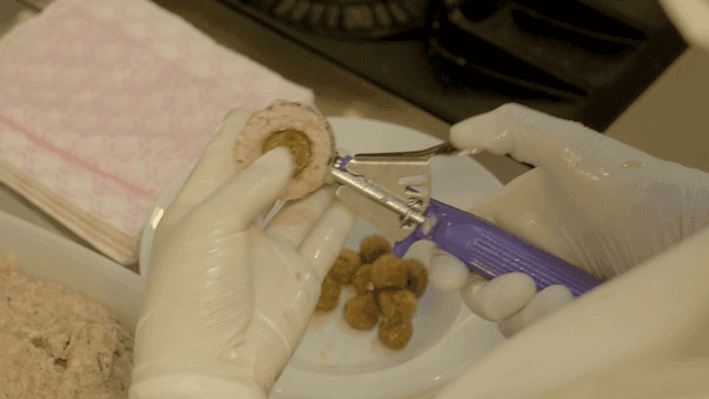 Chef preparing meatballs with scoop