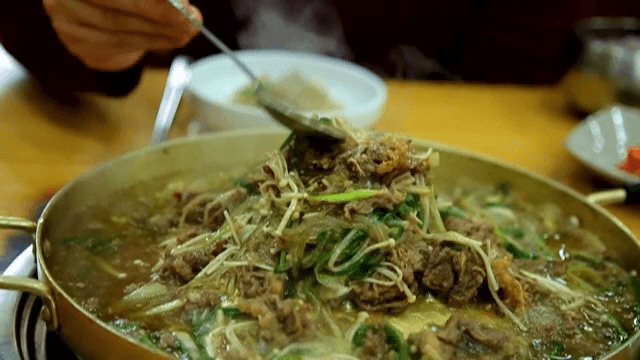 Warm Bulgogi Hot Pot topped with chives and mushrooms