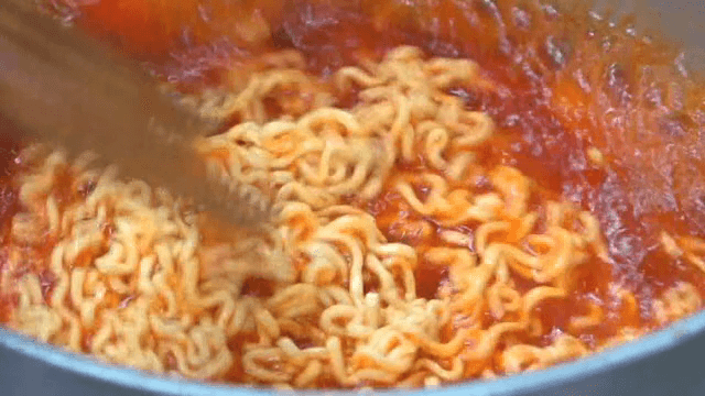 Cooking ramyeon noodles in a pot