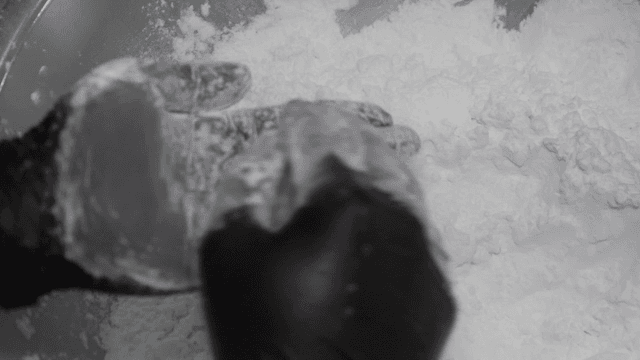 Hands kneading dumpling dough in bowl