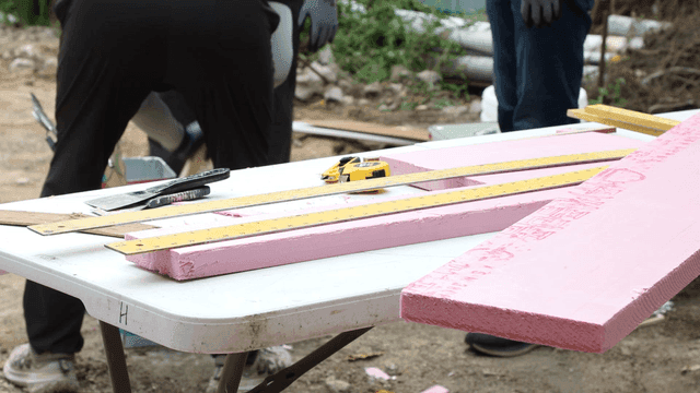 Workers preparing materials on a table