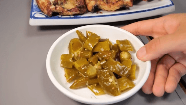 Grilled eel and pickled peppers on a table