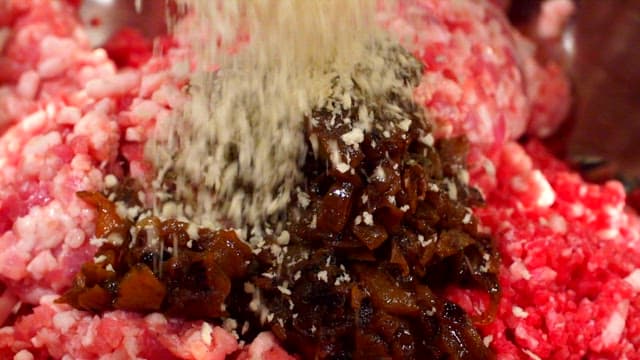 Mixing meat and breadcrumbs to make patty dough