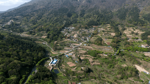 Aerial view of a rural village and farmland