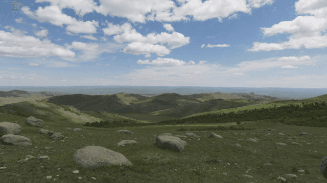 Expansive mountain landscape under a blue sky
