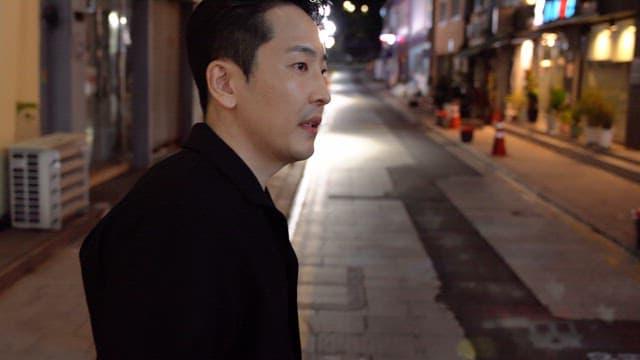 Man standing on a quiet city street at night