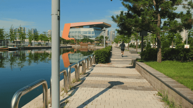 Person jogging along a riverside path