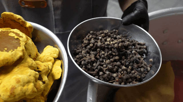 Bowl containing yellow sacred mushrooms and hackberry fruits
