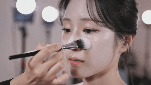 Makeup artist applying white foundation