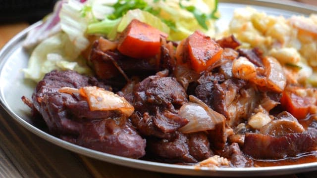 Dining scene of enjoying a delicious meat and vegetable stir-fry on a plate