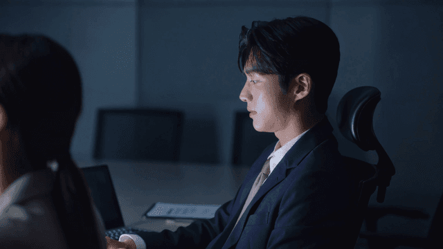 Office workers concentrating on business meeting in dark room