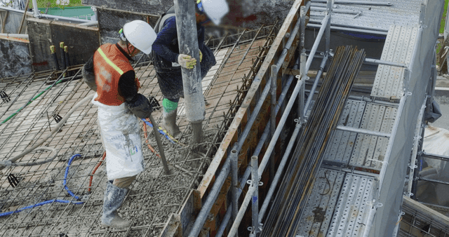 Construction workers pouring concrete