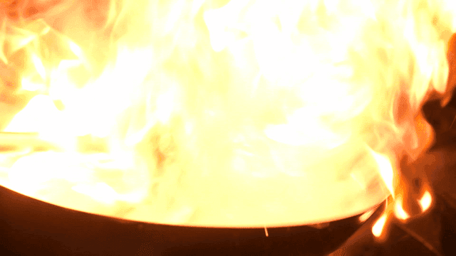 Flames rising from wok