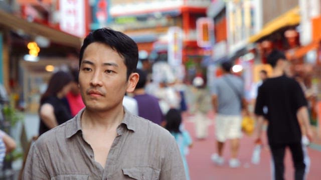 Man walking through a busy street market