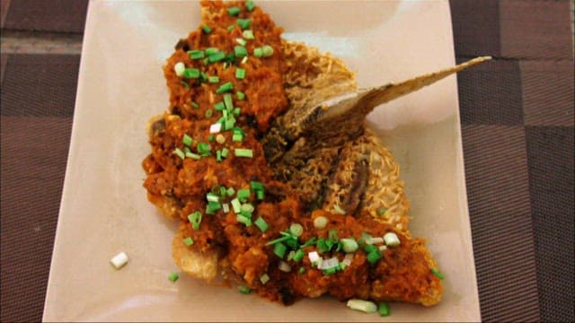 소스와 채소가 얹힌 생선 튀김