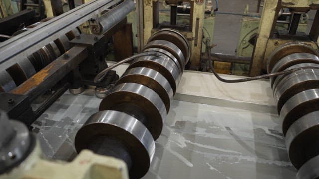 Metal rollers in a factory setting