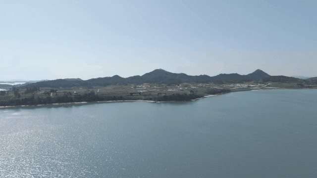 Coastal aquaculture with distant mountains