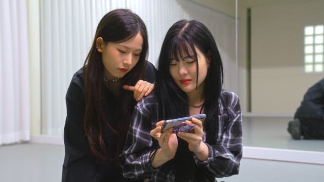 Friends sharing content on a smartphone