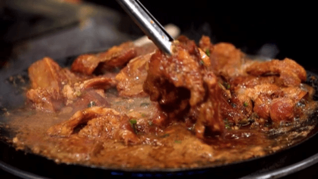 Marinated galbi sizzling over a hot pan