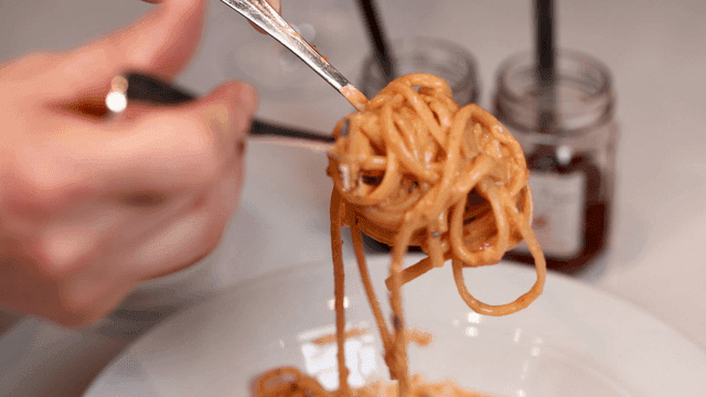 Rosé pasta twirled with fork