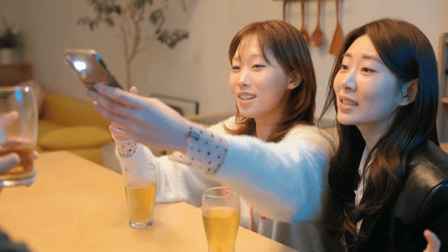 Friends taking pictures while drinking beer