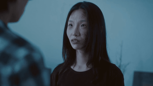 Woman with bruised face talking in living room