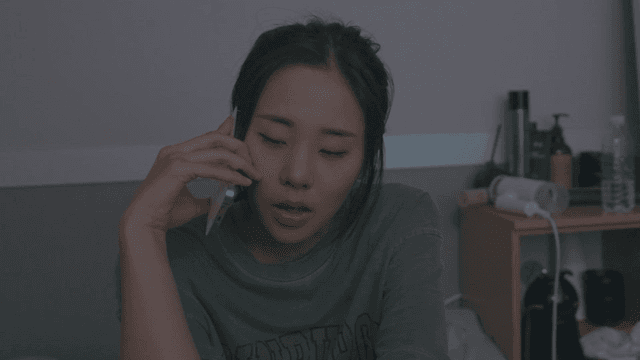 Woman talking on the phone in her bedroom
