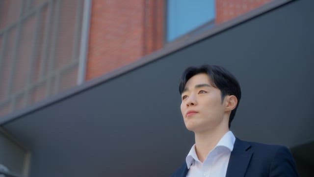 Man standing in front of a red building