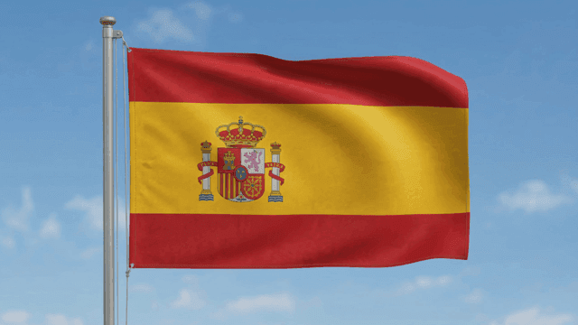 Spanish flag waving against a clear sky