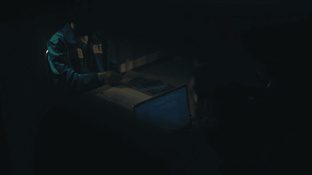 Prisoner being interrogated in dark interrogation room