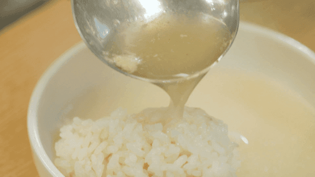Whole chicken broth poured over rice