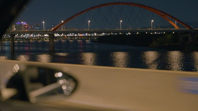 Night Drive Overlooking City River and Bridge