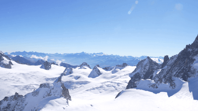 Snow-covered mountain peaks under clear sky