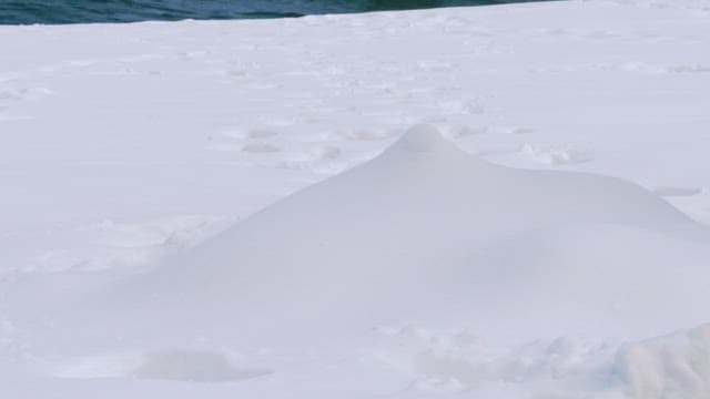 Snow-covered beach with footsteps