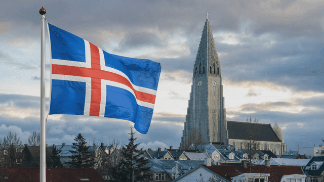 Icelandic flag waving near a tall church