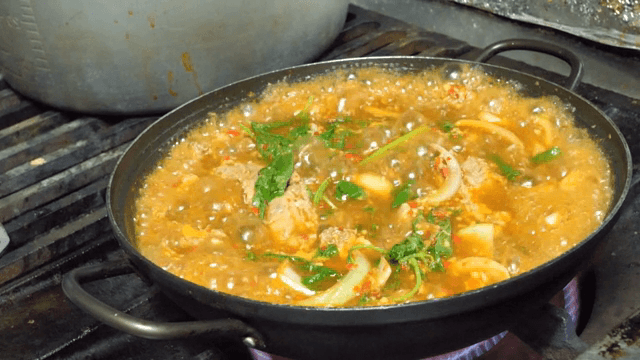 Spicy Braised Pork Galbi boiling on a gas stove
