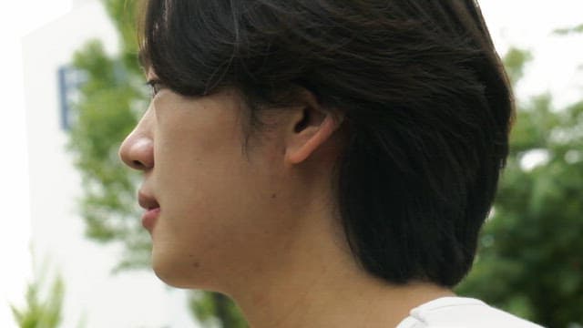 Young man smiling in a green park