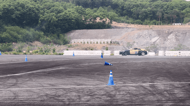 Car maneuvering through cones on a track
