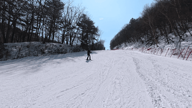 Skiers coming down snow-covered slope
