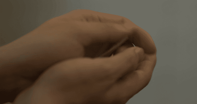 Hands holding Korean currency and coins