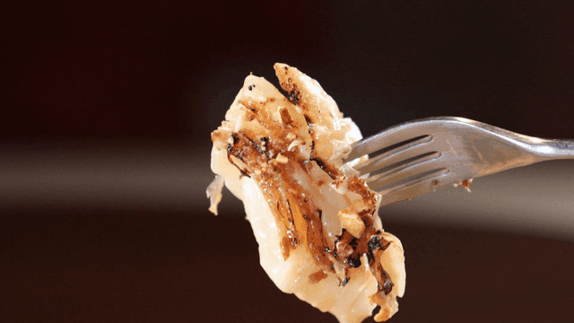 Grilled cabbage skewered with fork