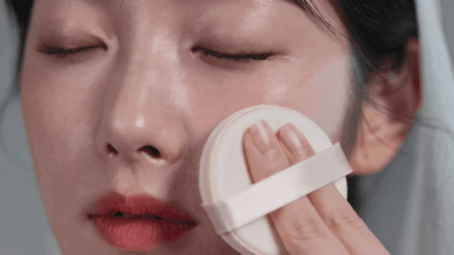 Bride applying makeup with cushion puff