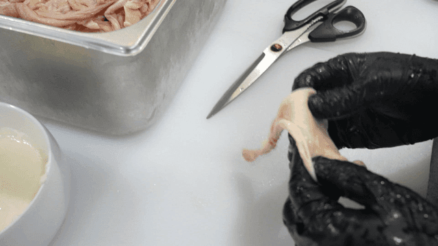 Preparing chicken skin in kitchen