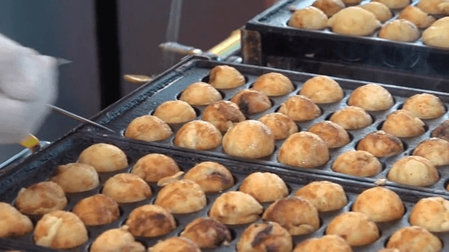 Cooking octopus balls on a hot griddle