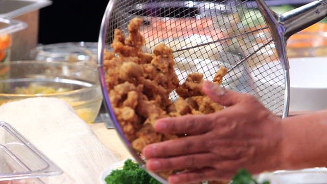 Fried pork being plated