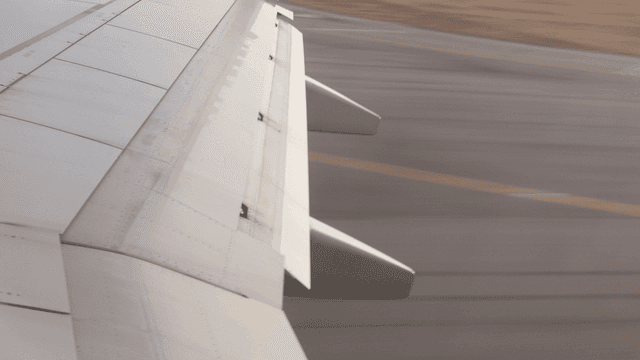 Airplane wing during takeoff on runway