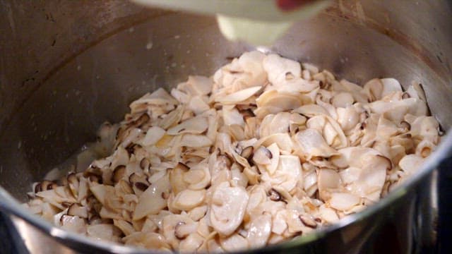 Mushrooms being cooked with creamy sauce