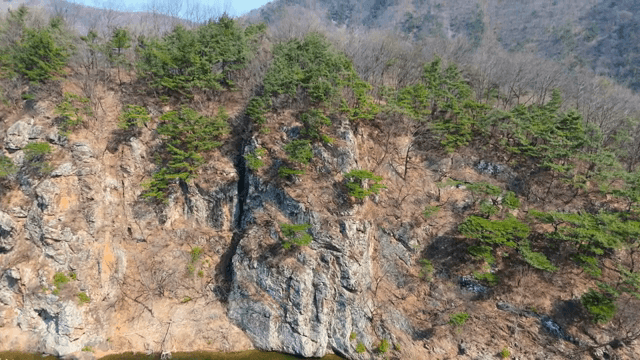 Serene river flowing by rocky cliffs