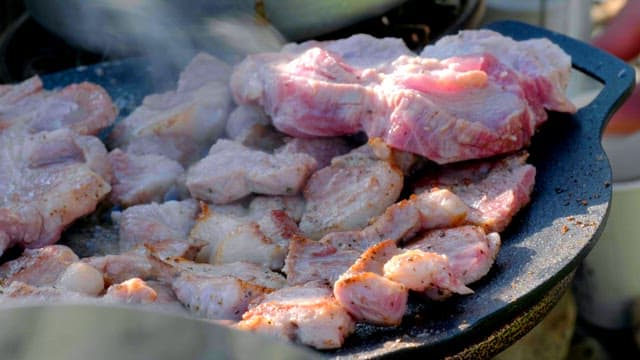 Meat grilling on a hot pan