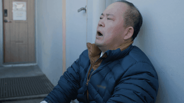Man sitting leaning against wall